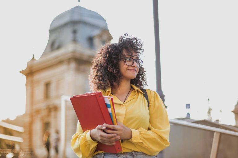 student holding books