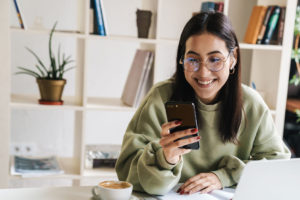 College student using phone for telehealth