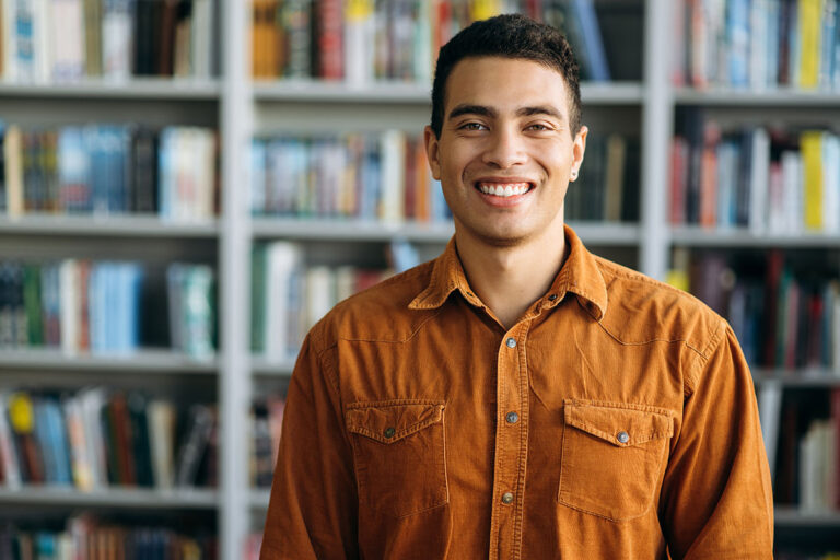 Student smiling in library