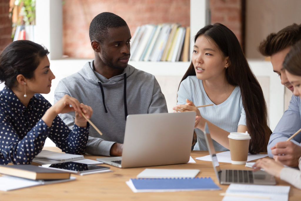 College students gathered around a computer