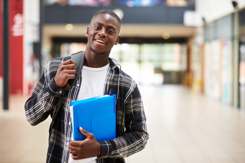 College student smiling in hallway