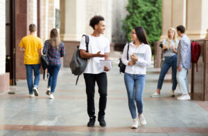 Students walking in hall smiling