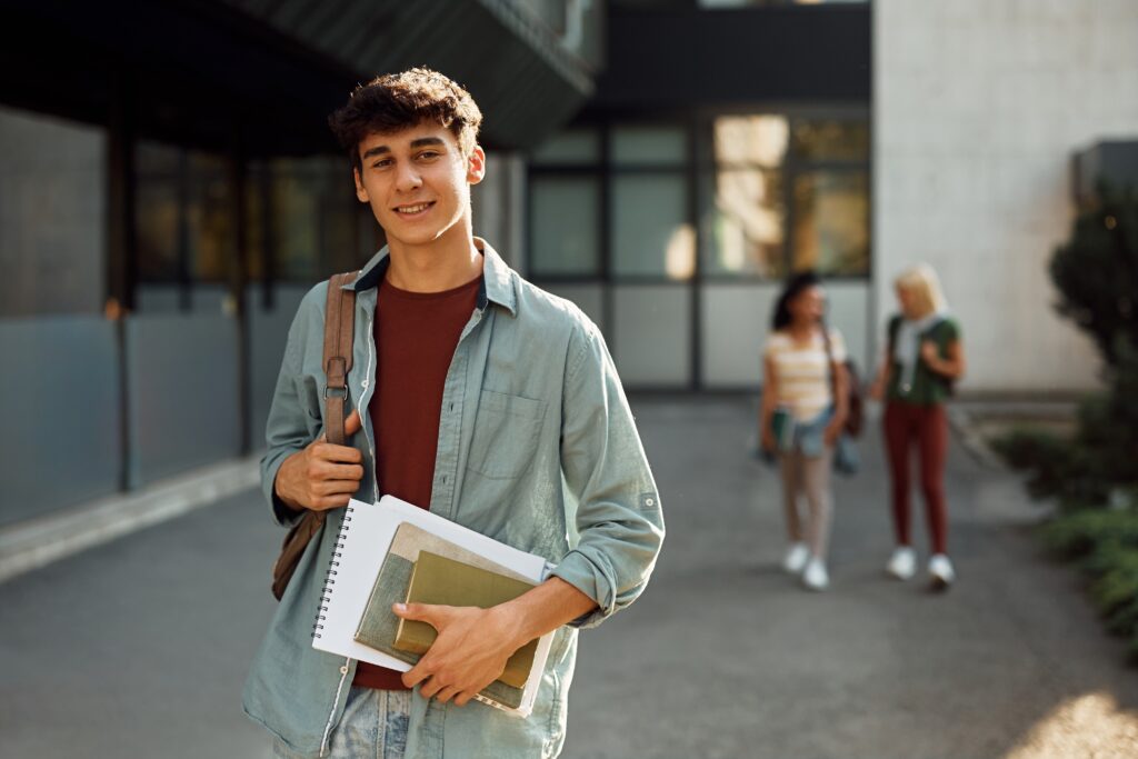 Young Student In Front Of University Building