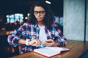 College student looking at watch