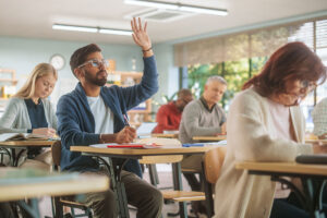 College student raising hand in class