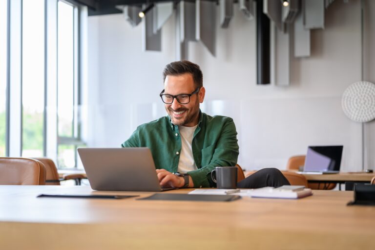 Confident,Handsome,Programmer,In,Eyeglasses,Developing,Software,Over,Laptop,At