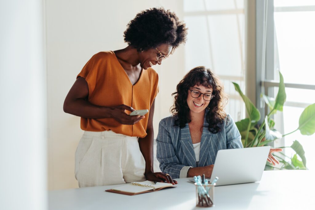 Happy,Professional,Women,Collaborating,With,Enthusiasm,In,A,Modern,Office