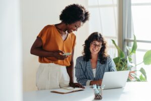 Happy,Professional,Women,Collaborating,With,Enthusiasm,In,A,Modern,Office
