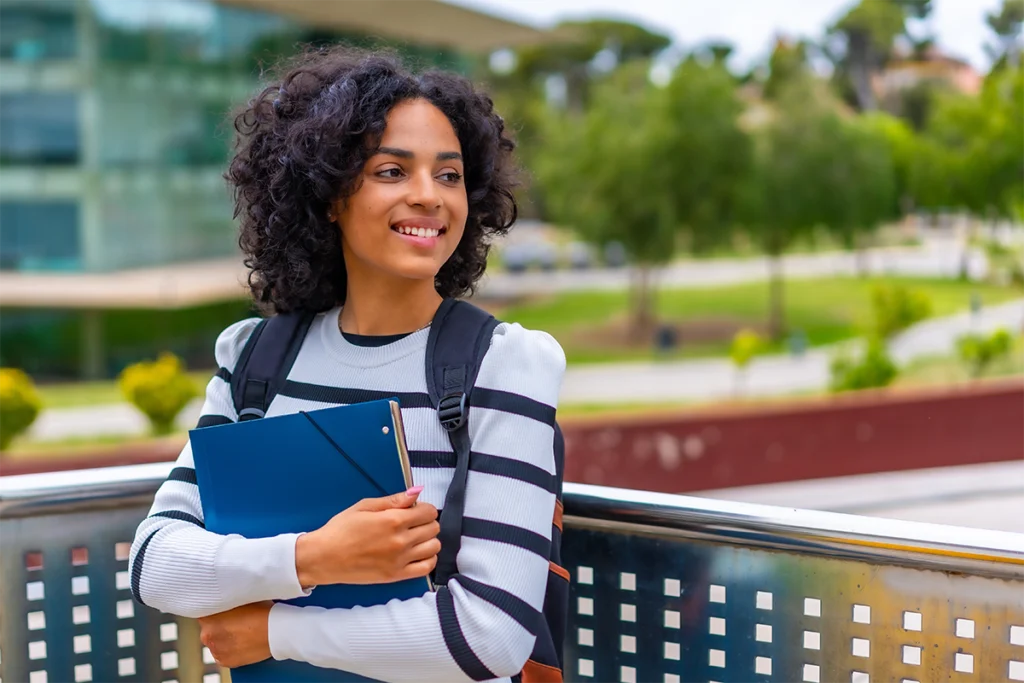 College student standing outside on balcony