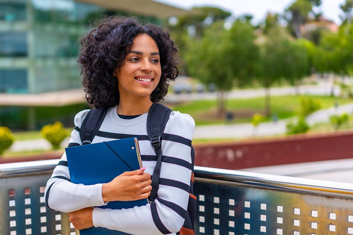 College student standing outside on balcony