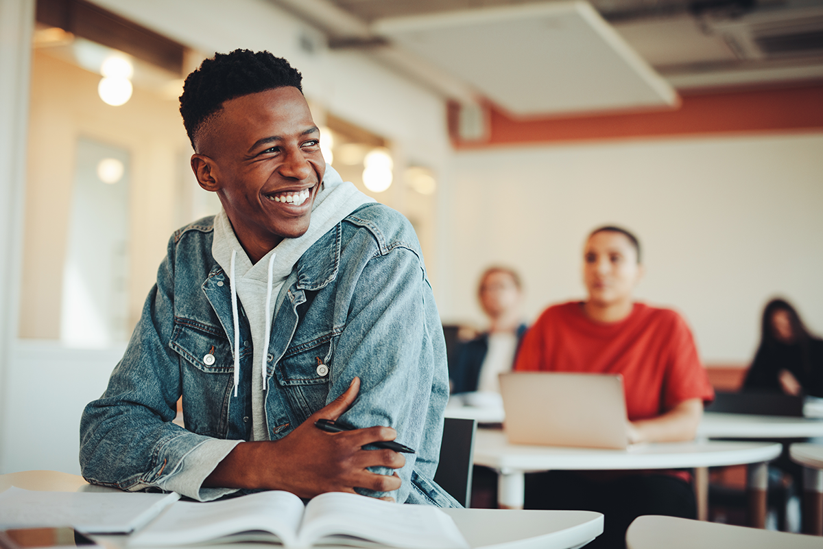 Male college student sitting at desk