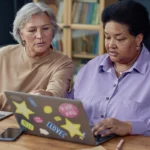 Portrait of two senior women using laptops