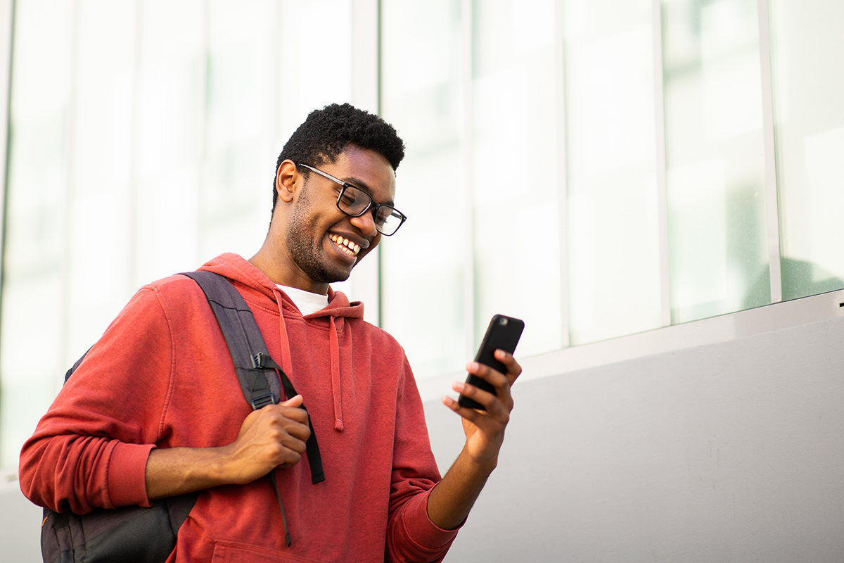 College student holding phone